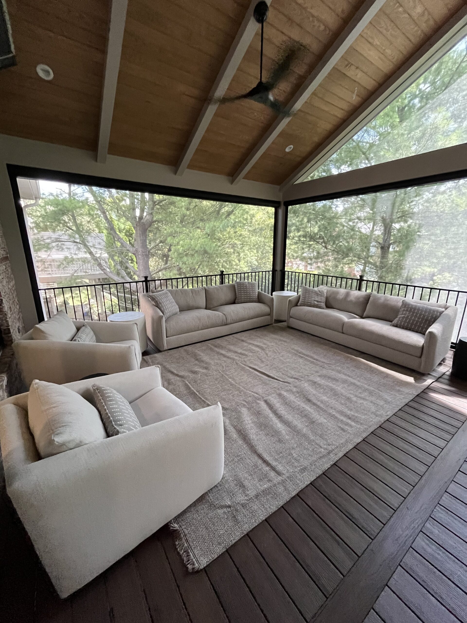 Screened porch with vaulted wood ceiling and outdoor seating